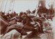 Immigrants in the steerage section of the S.S. Pennland, wrapped in blankets on the deck of the ship. Photo dated 1893, by Byron Company (NY, NY)