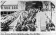 Immigrants walking across pier from bridge, Ellis Island